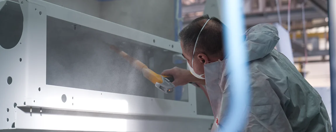 Powder coating – applying powder paint to steel components in a powder coating booth